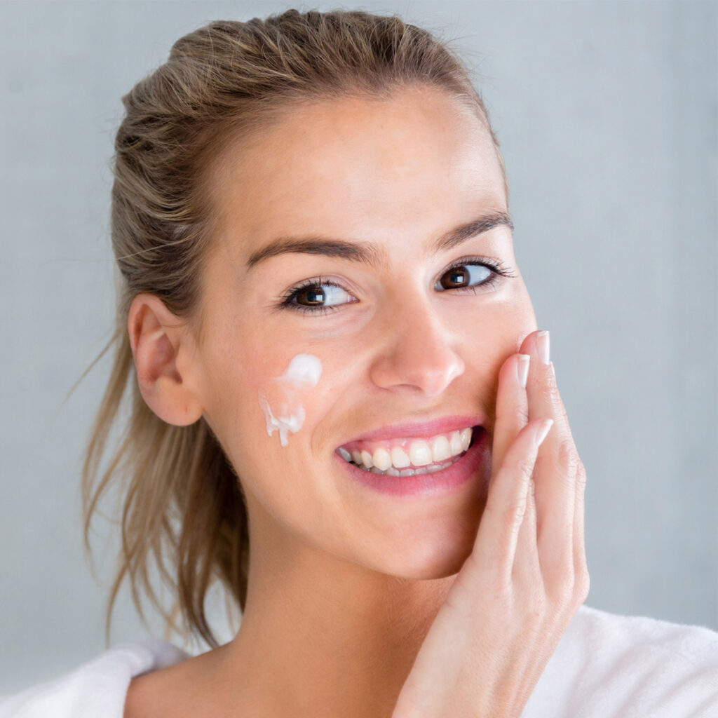 woman applying moisturizer