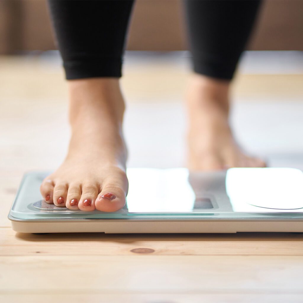 woman stepping on a scale