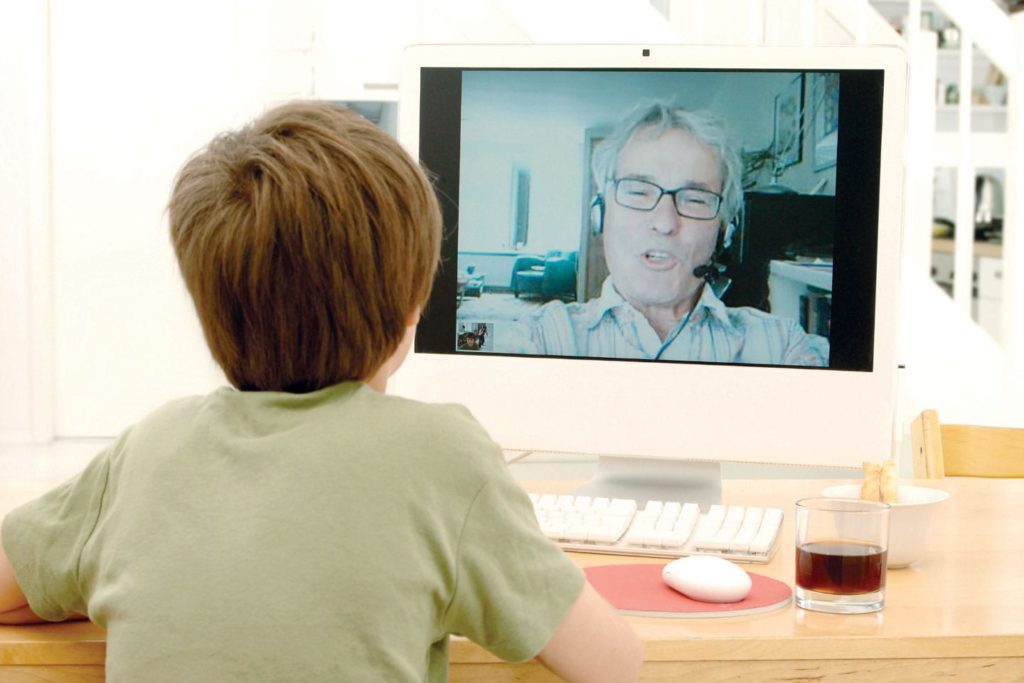 child talking with grandfather through video chat