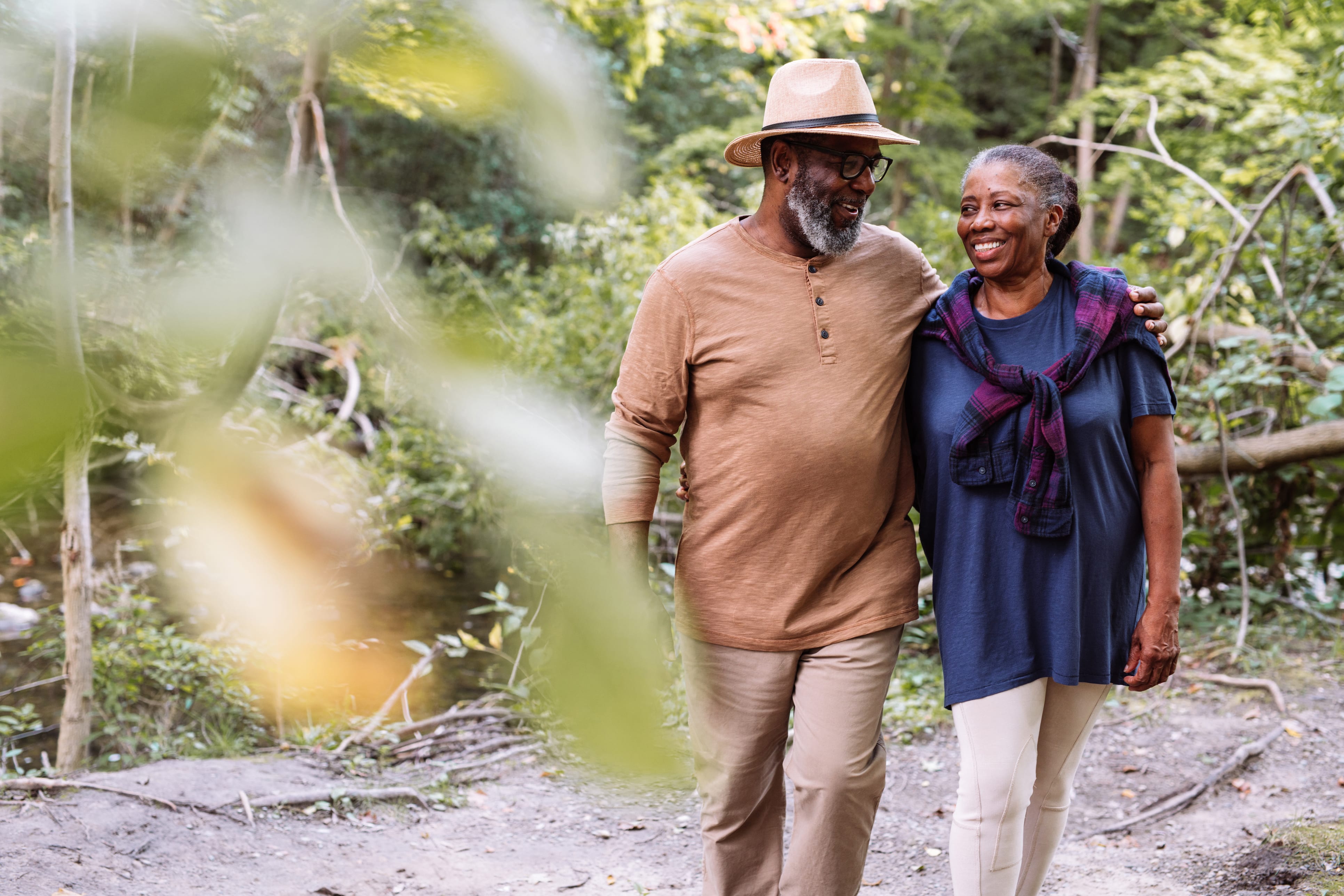 African-american man and woman walk together in the woods