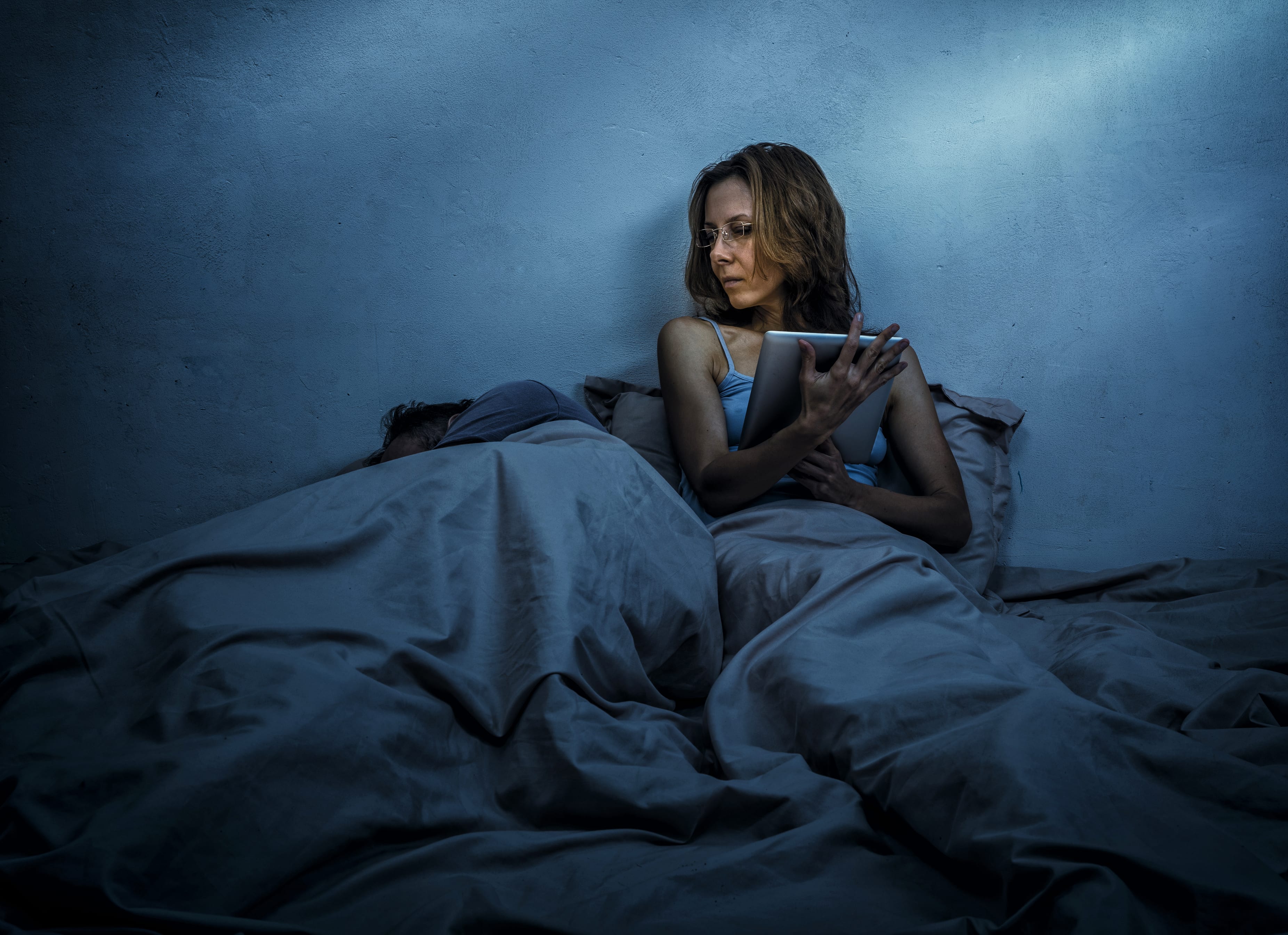 Woman social networking in bedroom