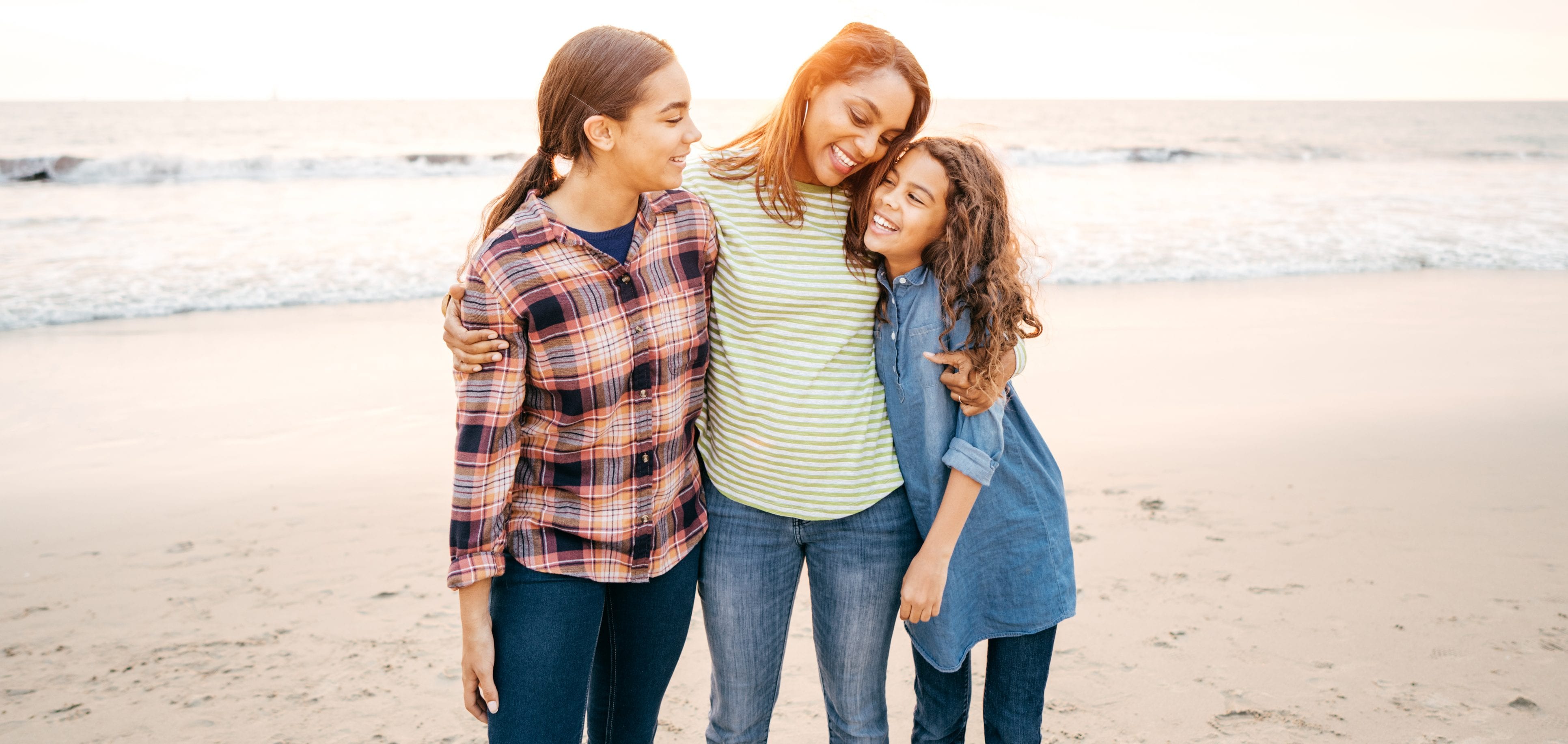Mother with two daughters on the beach