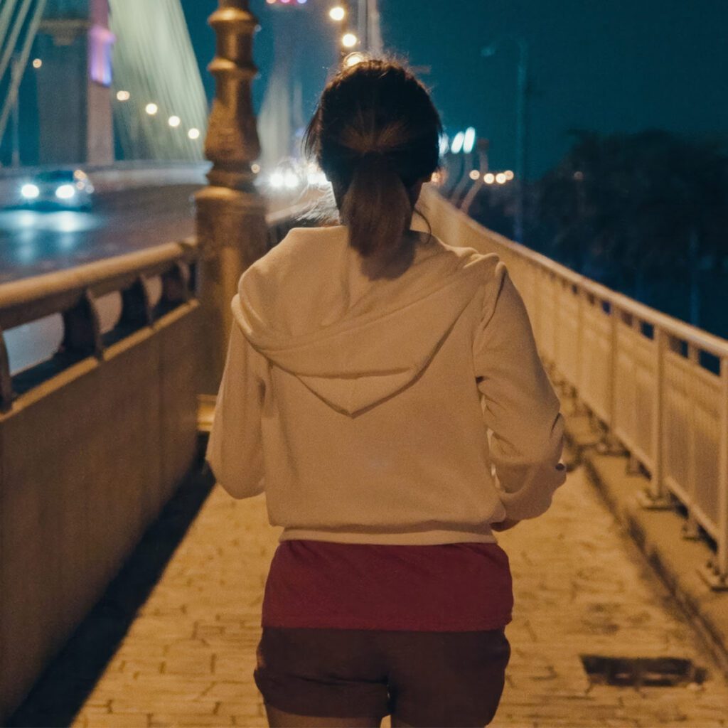 woman jogging in the city at night