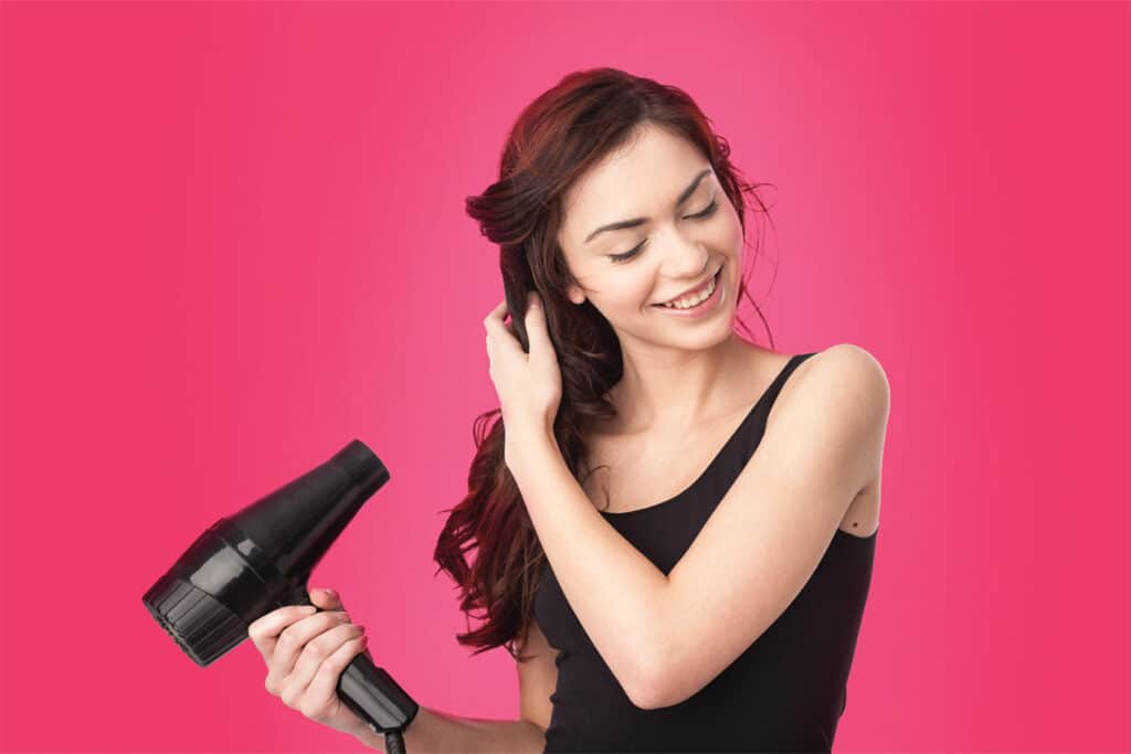 woman holding blow dryer