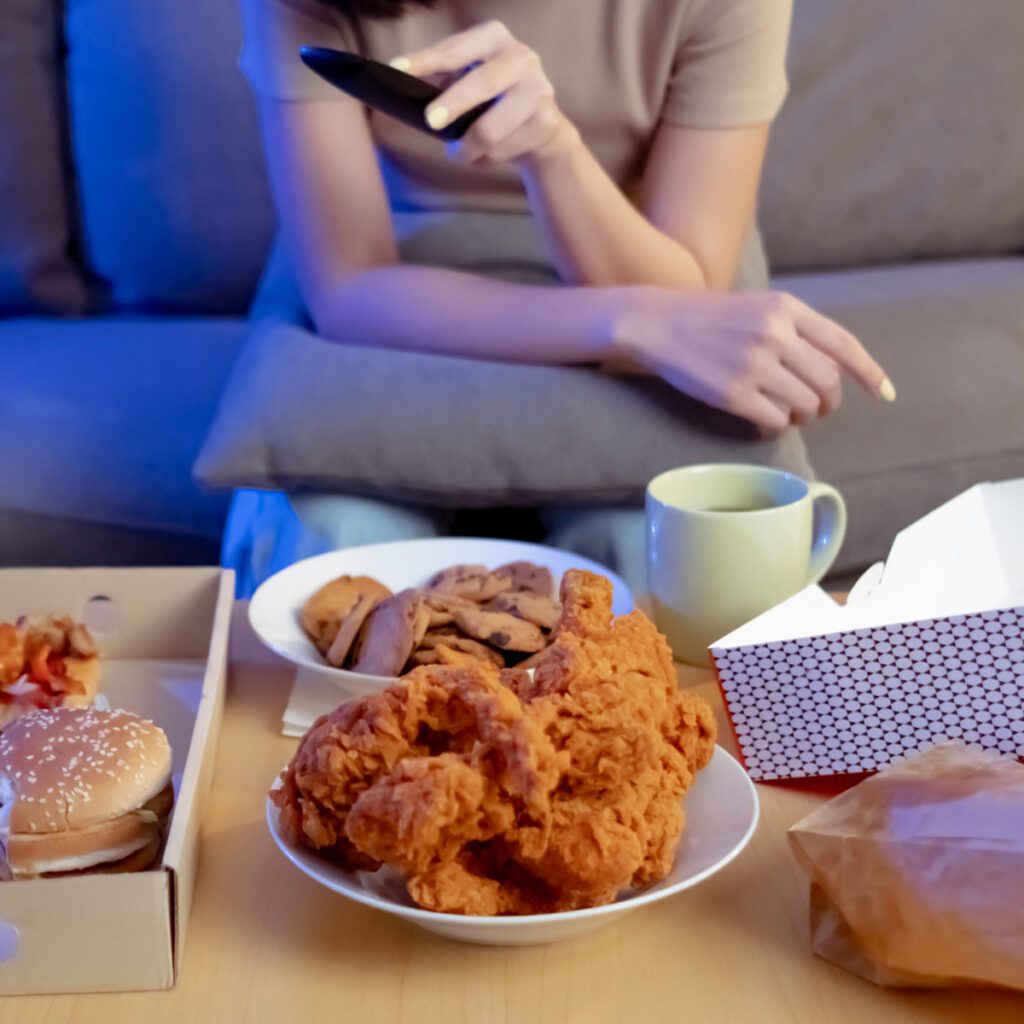 woman binging on junk food