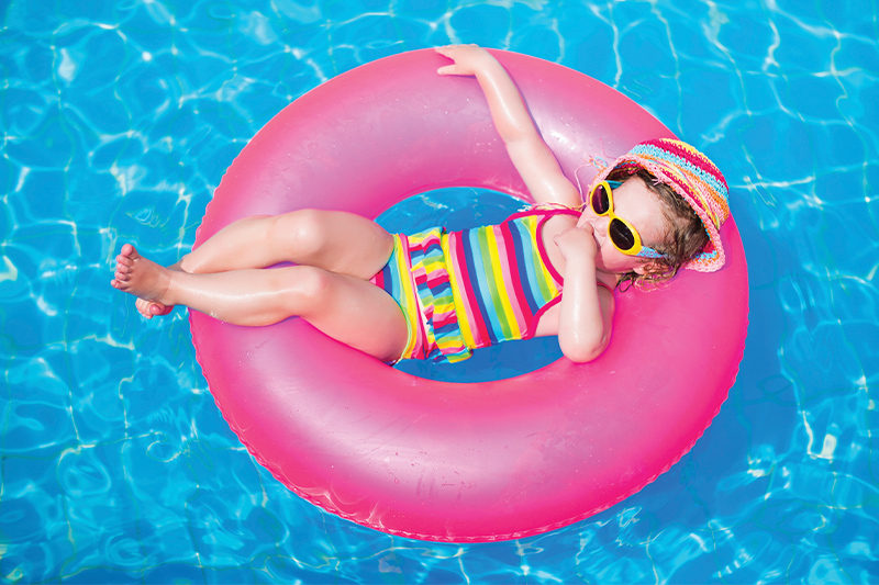 child on a float in a swimming pool