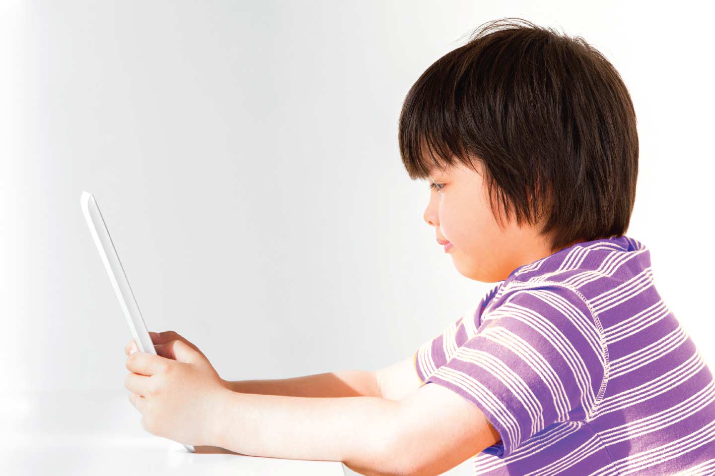 Male child playing on tablet device