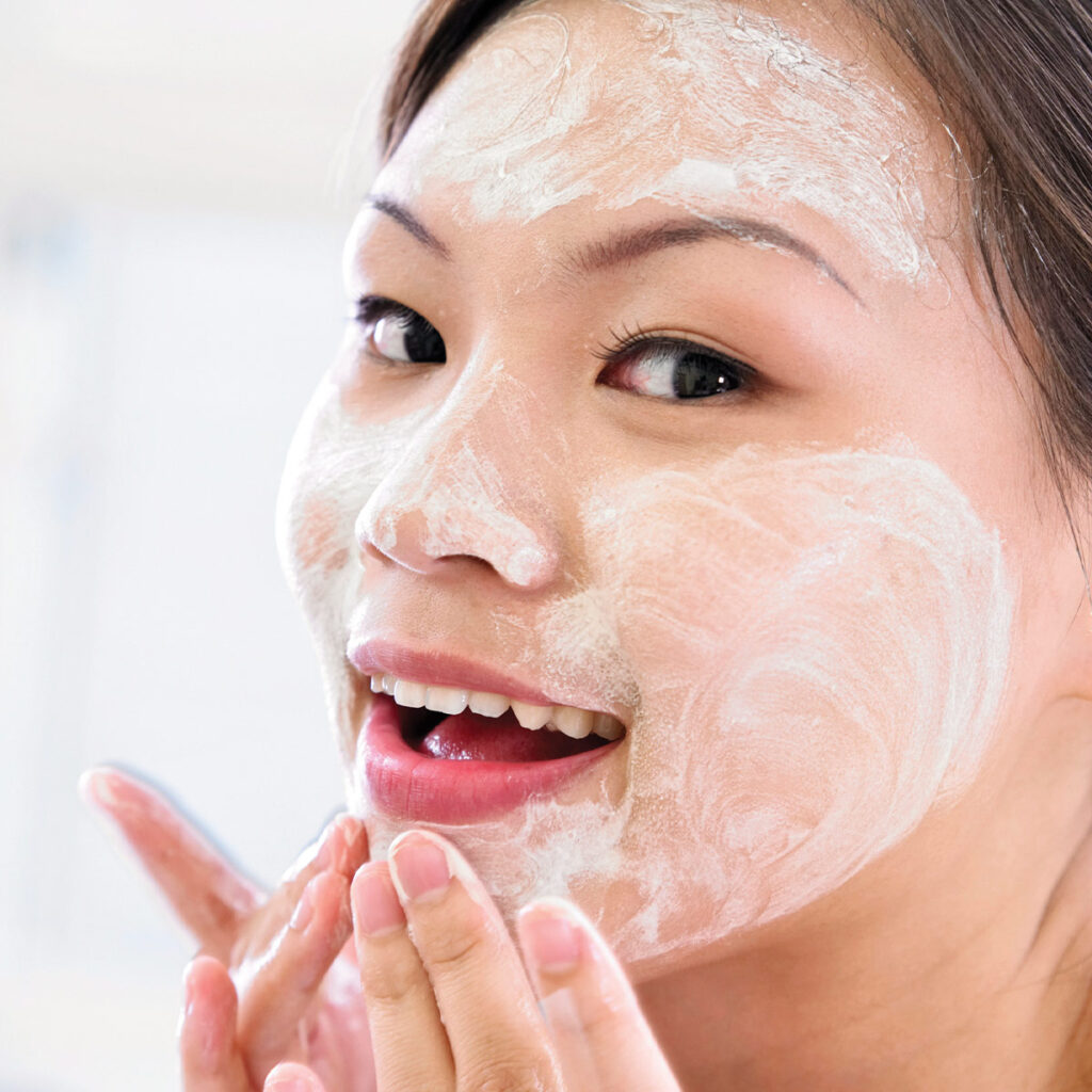 woman applying cleanser onto her face