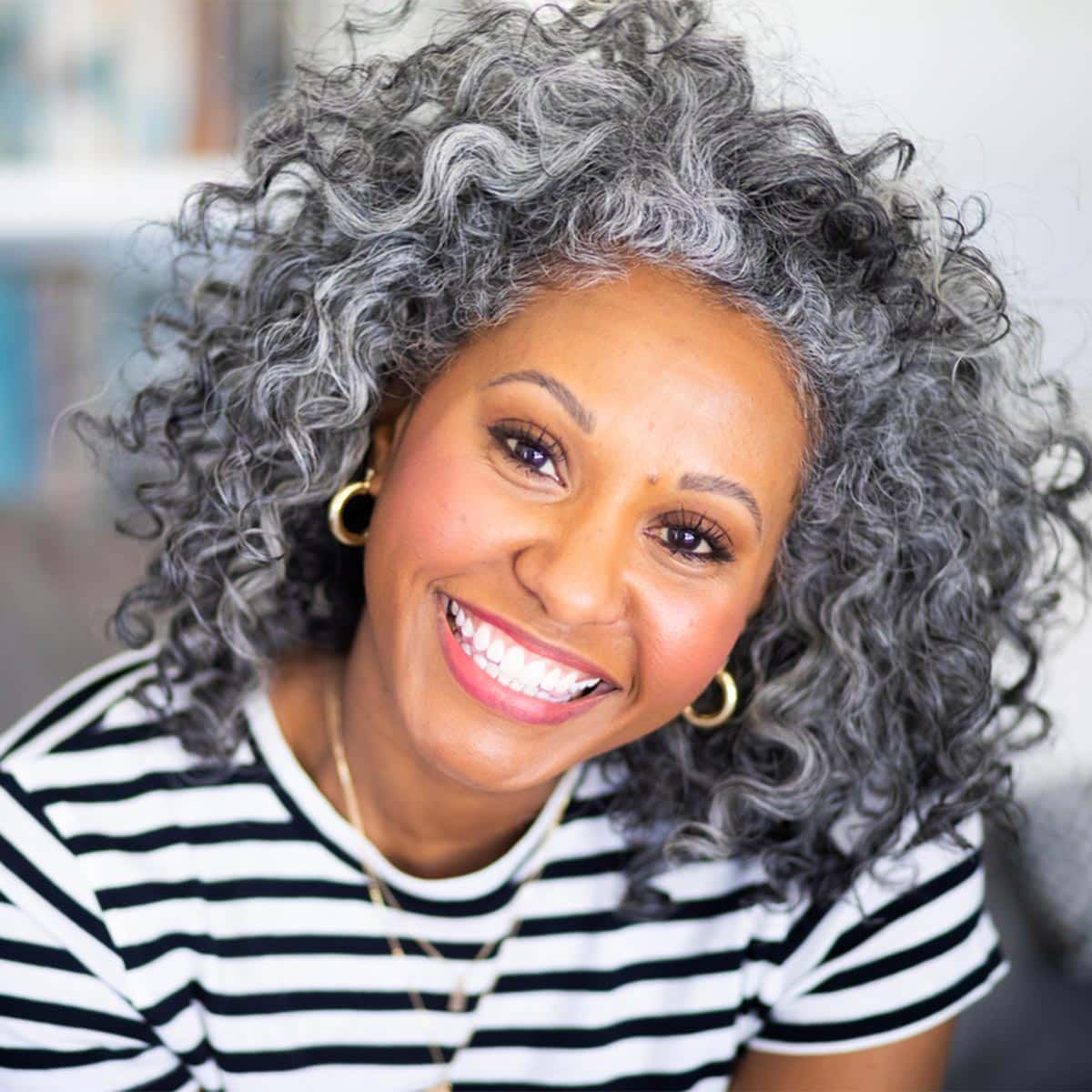 smiling woman with curly gray hair