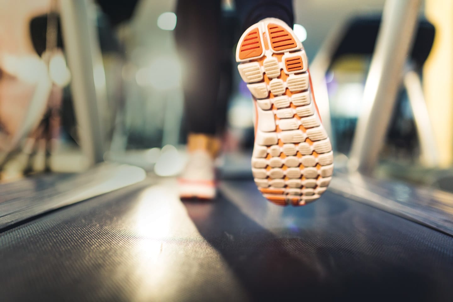 Stylistic photo of woman running on treadmill