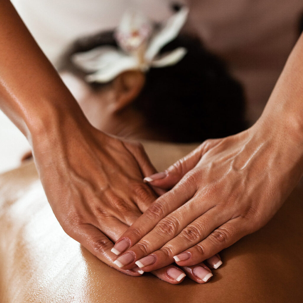 young woman getting back massage in a spa