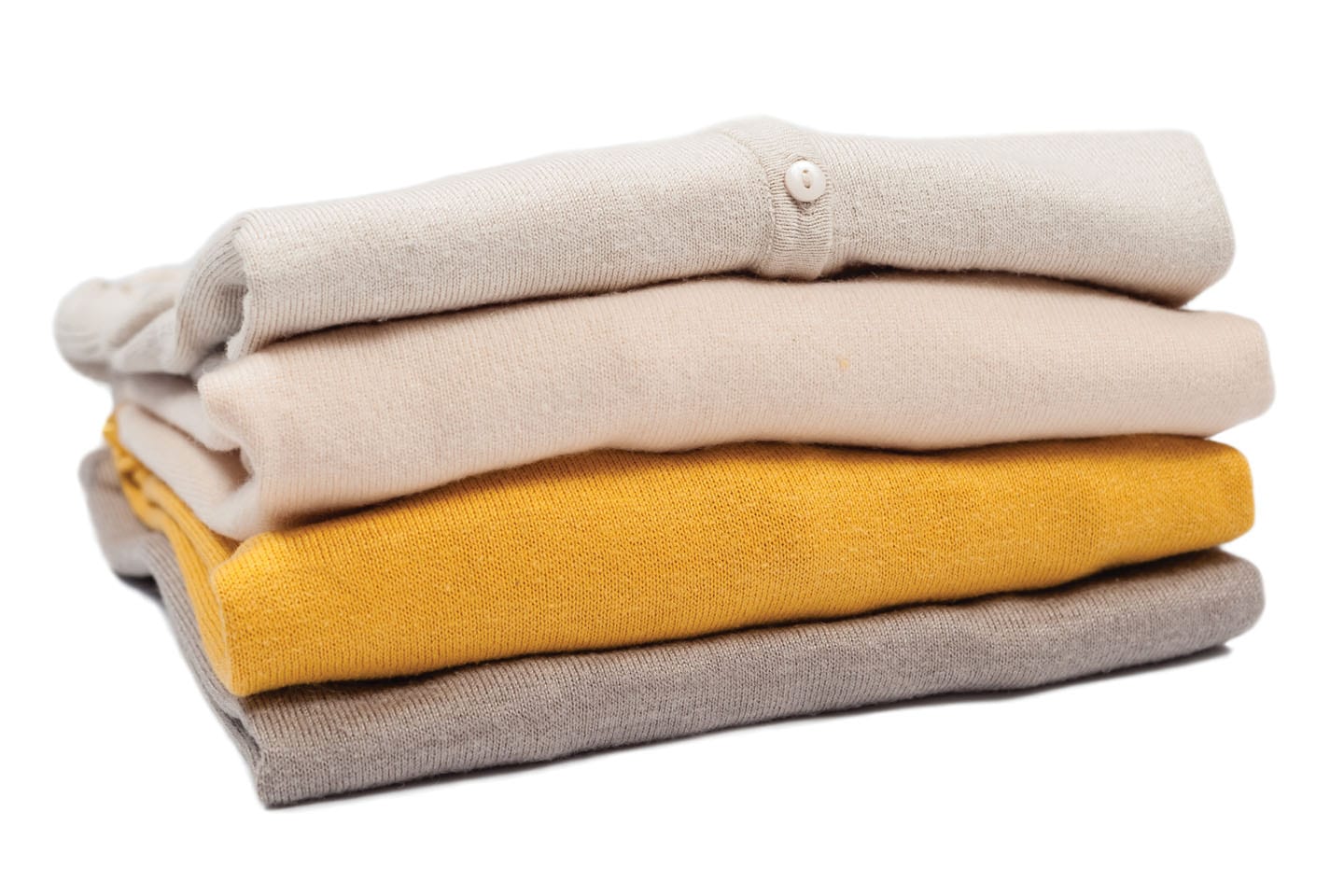 folded stack of cardigans and sweaters beige and yellow chattanooga