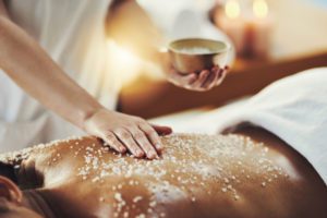 Closeup shot of a woman getting an exfoliating massage at a spa