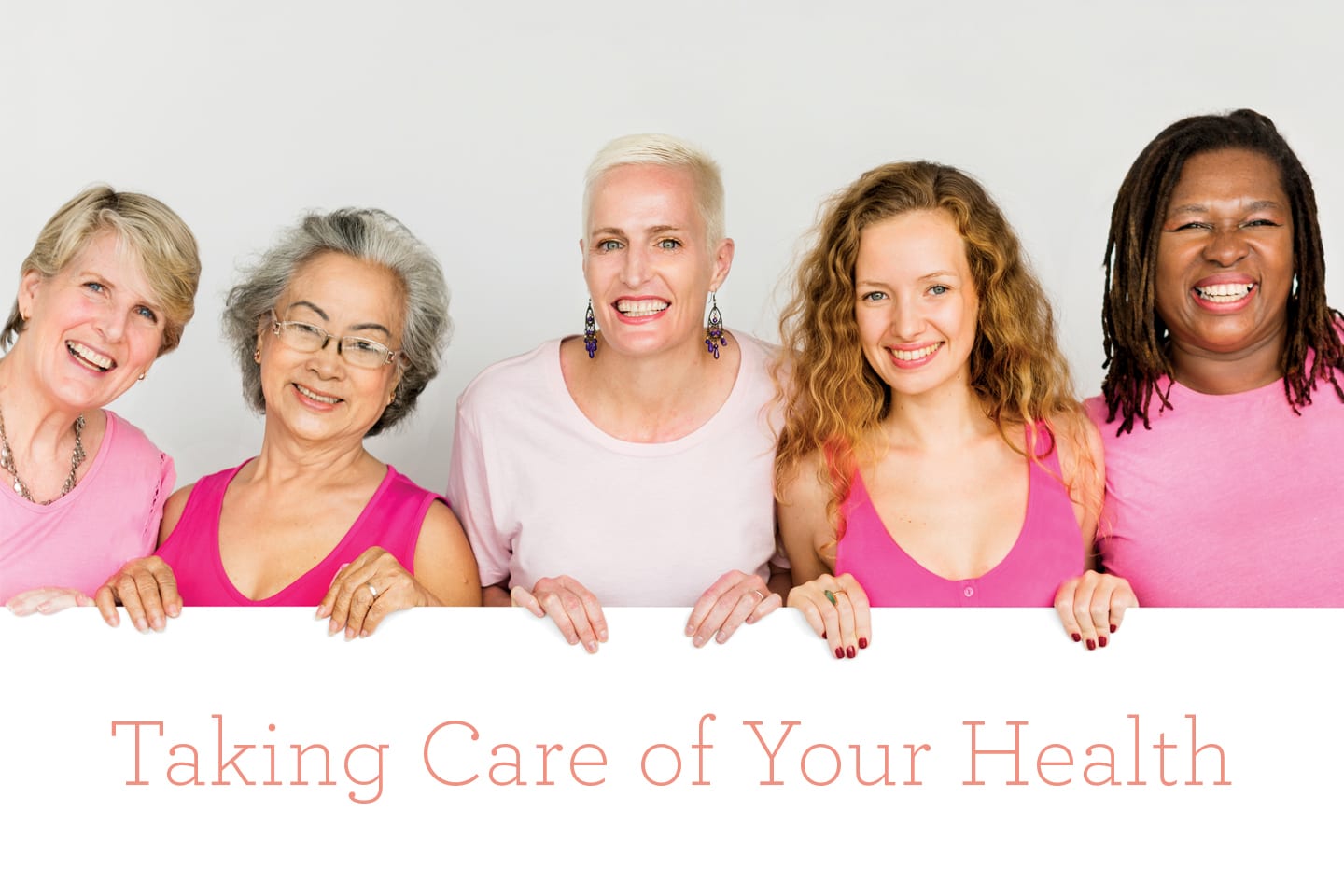 women wearing red and pink holding taking care of your health sign chattanooga