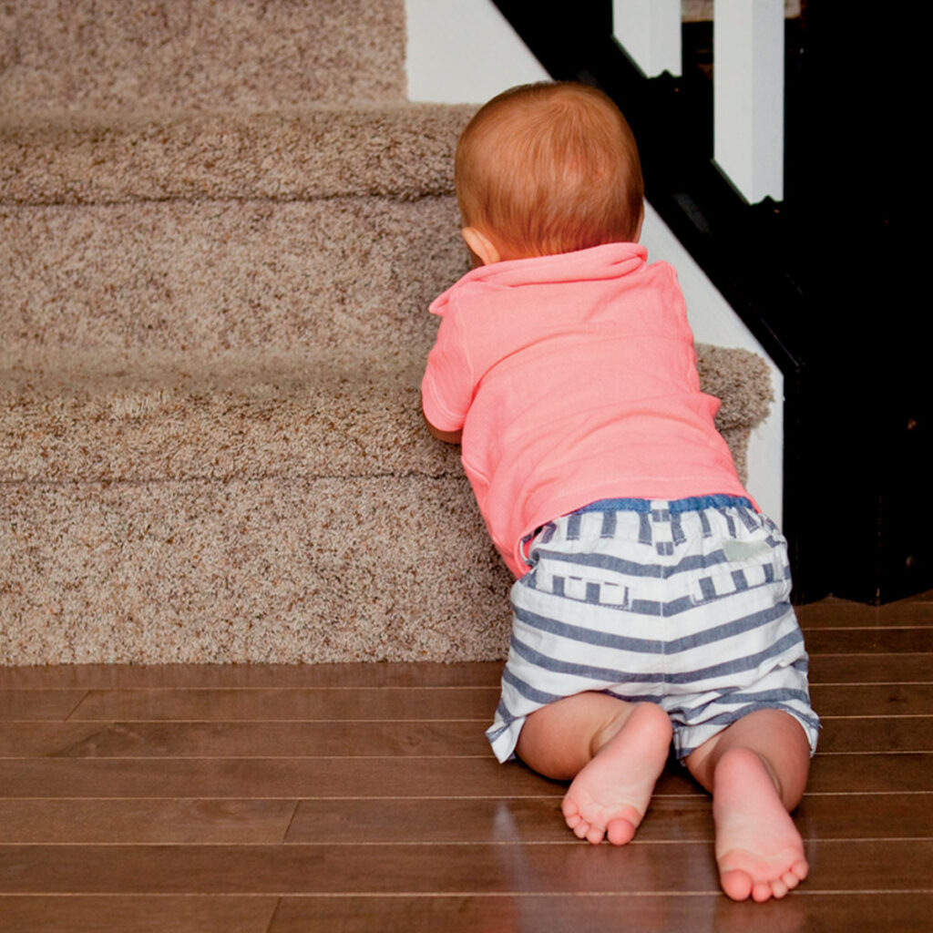 baby boy leaning on the stairs