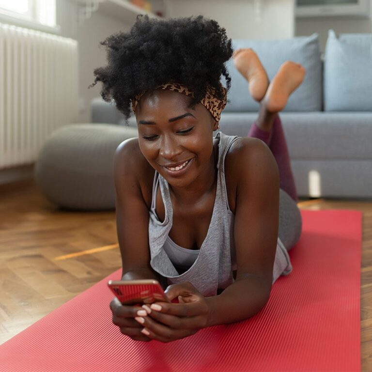 woman using a fitness app on her smartphone