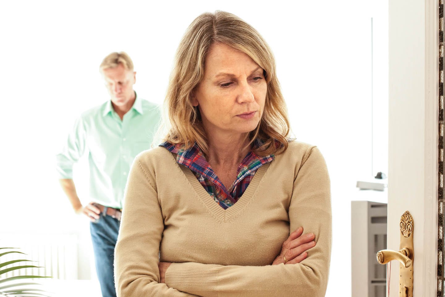 depression chattanooga mature woman with arms crossed and husband standing in background