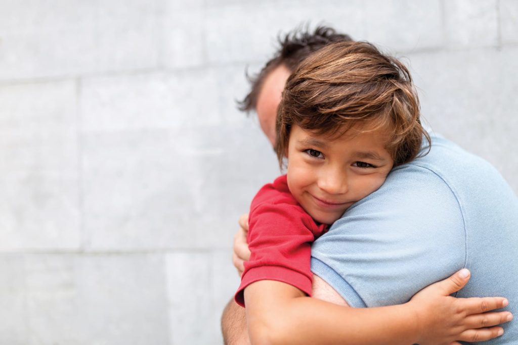 dad hugging happy little boy in chattanooga