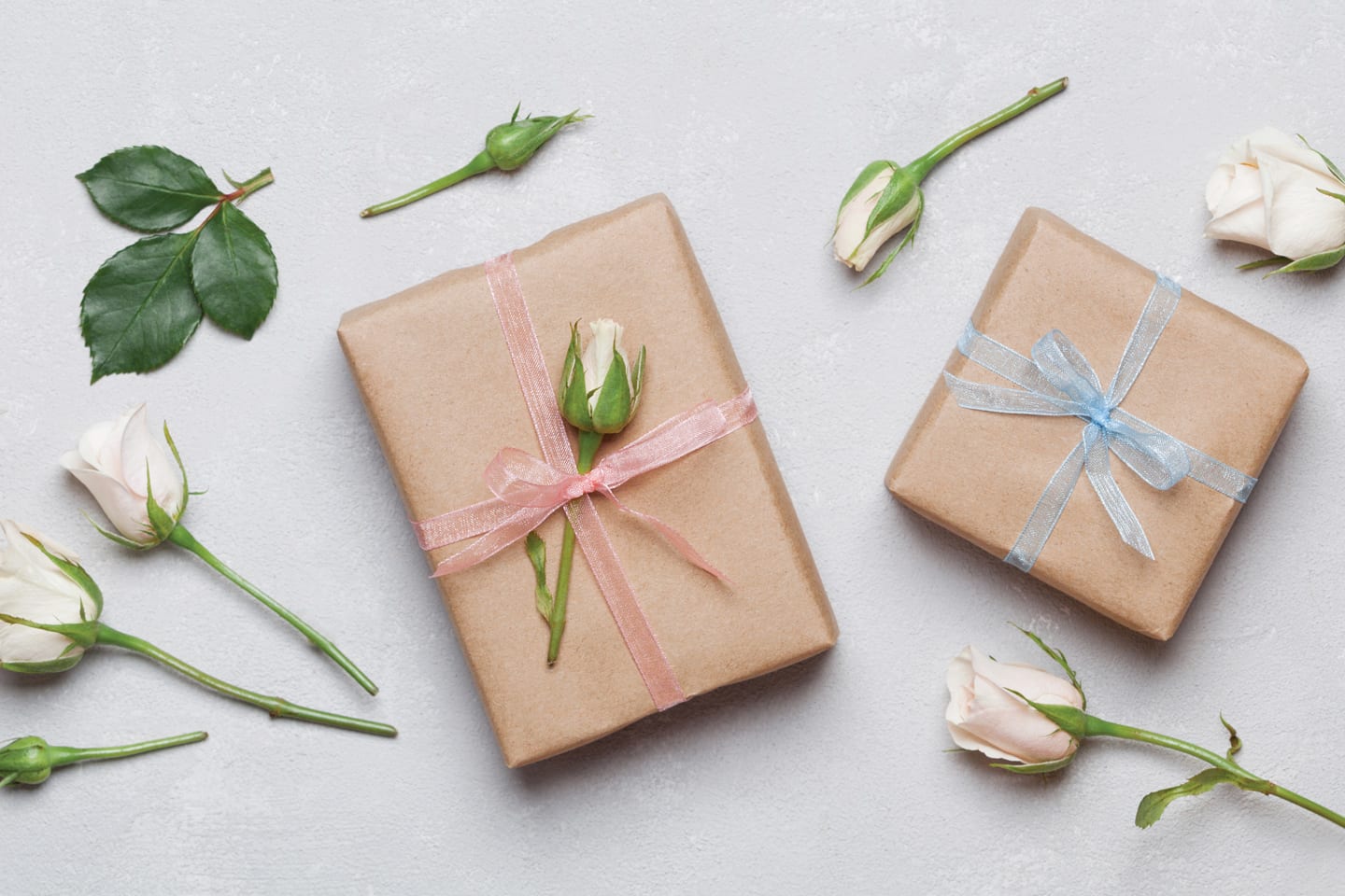 boxes wrapped in brown paper with white roses