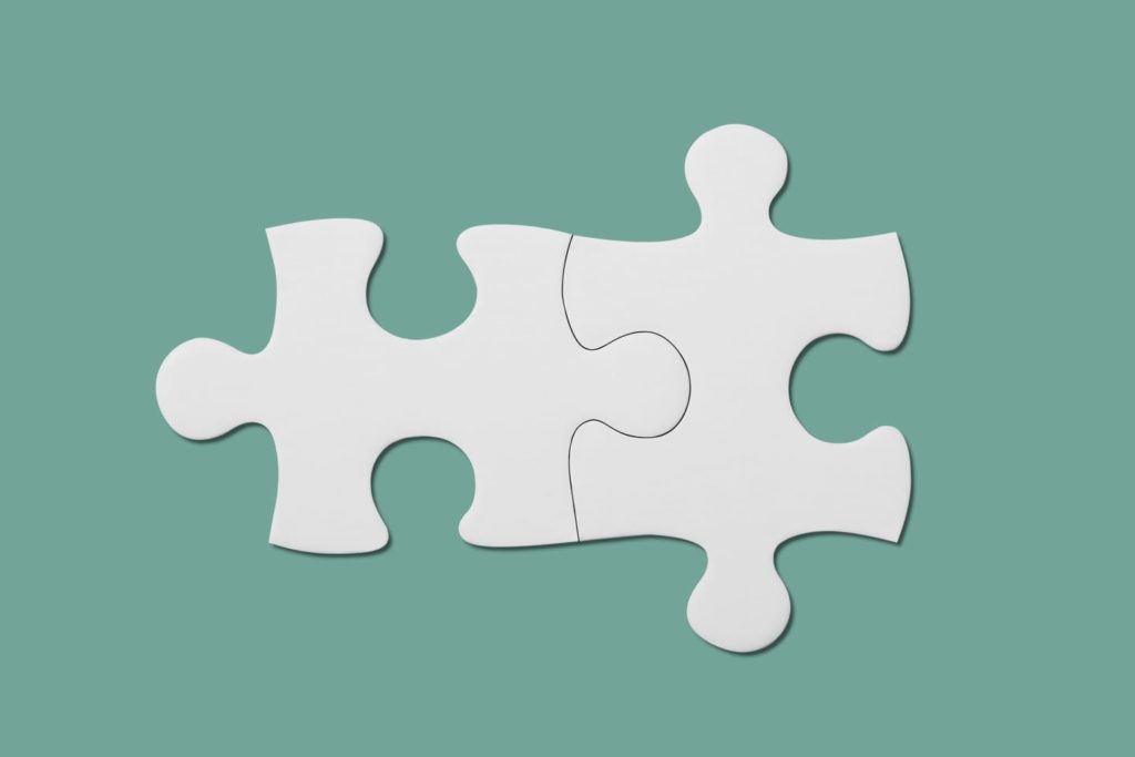 two puzzle pieces fitting together