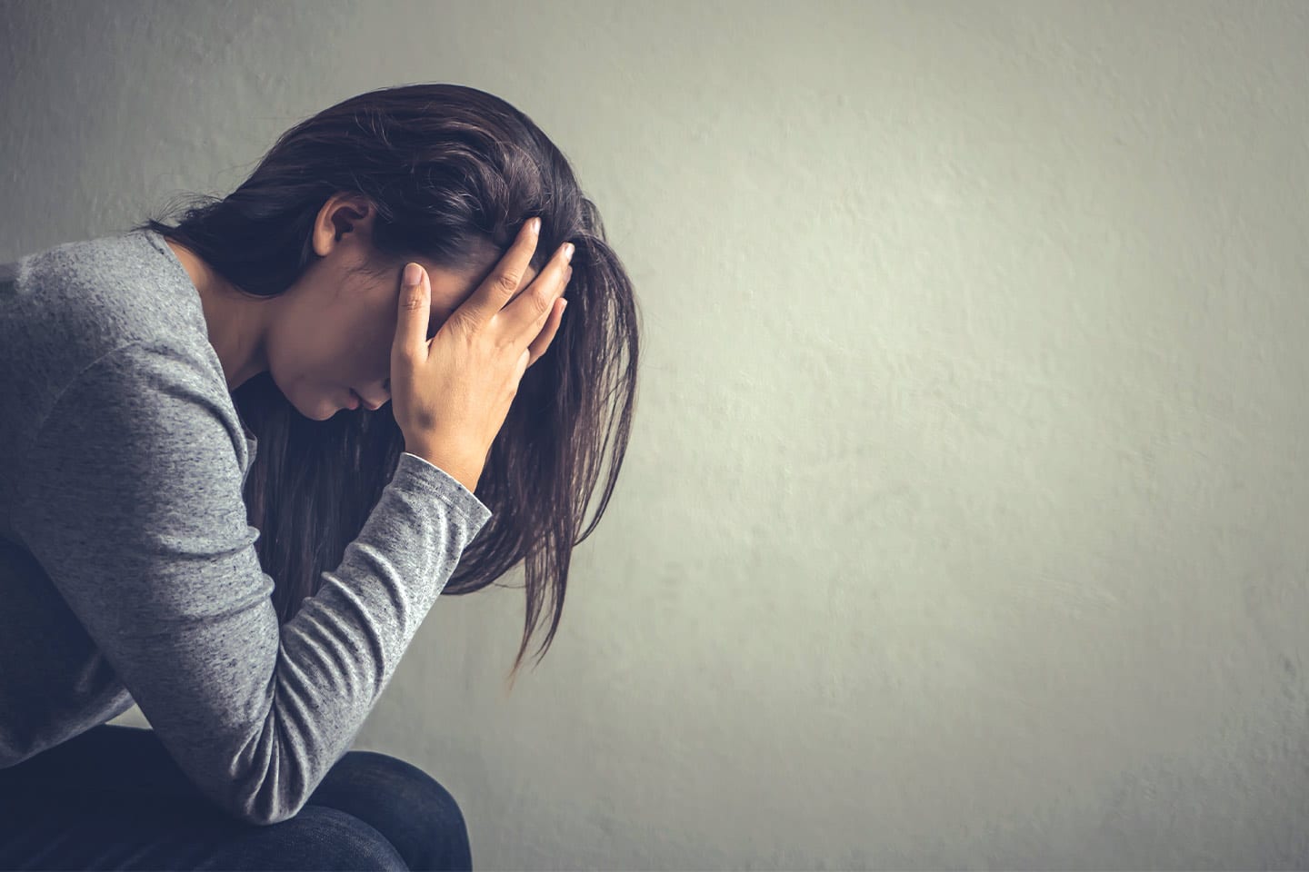 depressed woman suffering from emotional abuse sitting with head in hands in chattanooga