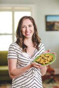 Megan Hanson chattanooga local holding a plate of her petite spinach frittatas