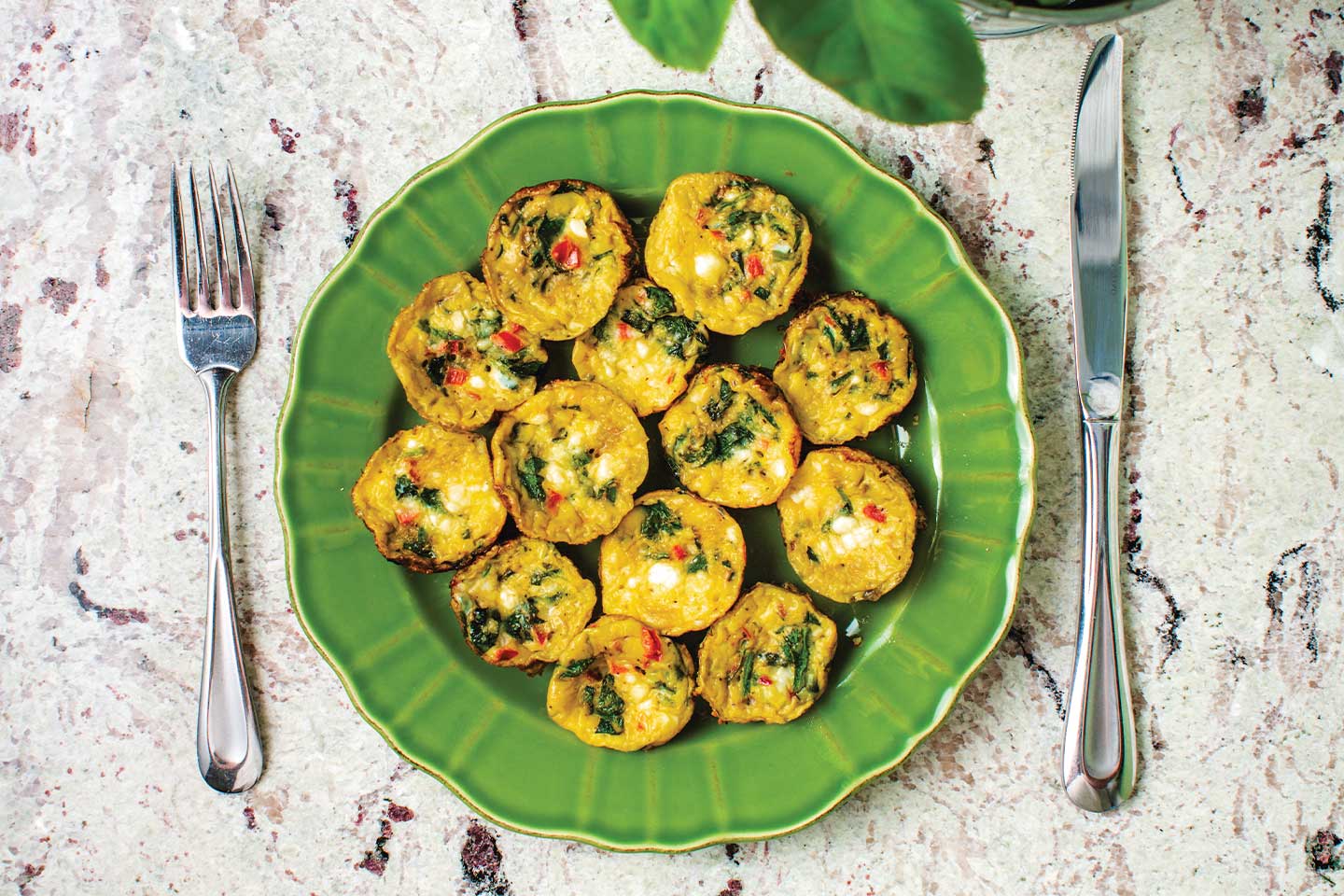 megan hanson's petite spinach frittatas on a green plate by a spinach plant in chattanooga