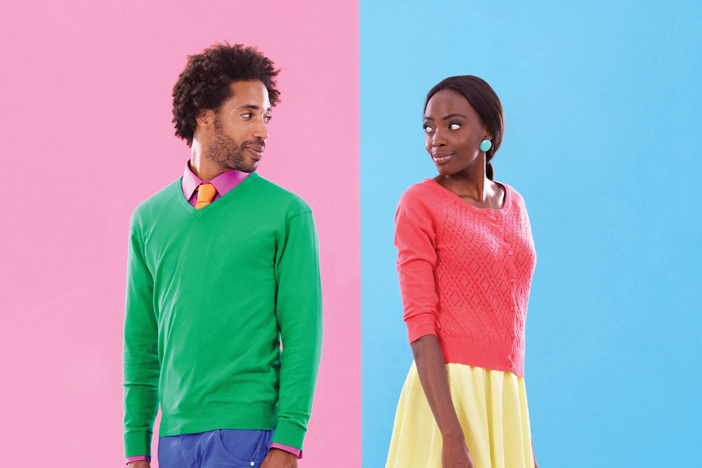 Man and woman in colorful clothes standing and looking back at each other