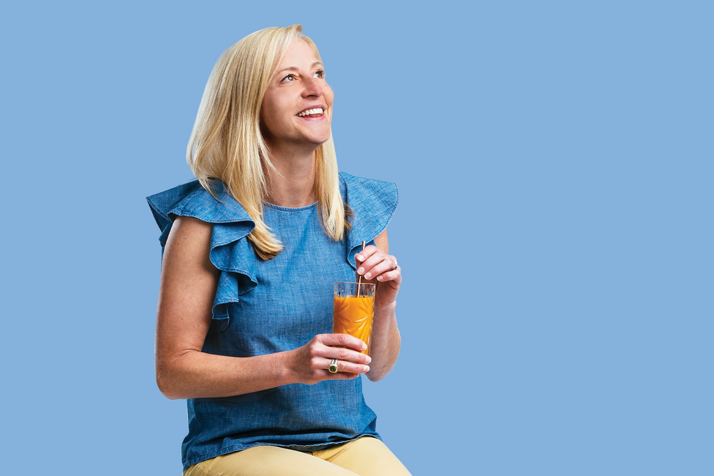 Amy Jo Osborn HealthScope Summer 2019 cover model sitting on stool drinking juice in chattanooga
