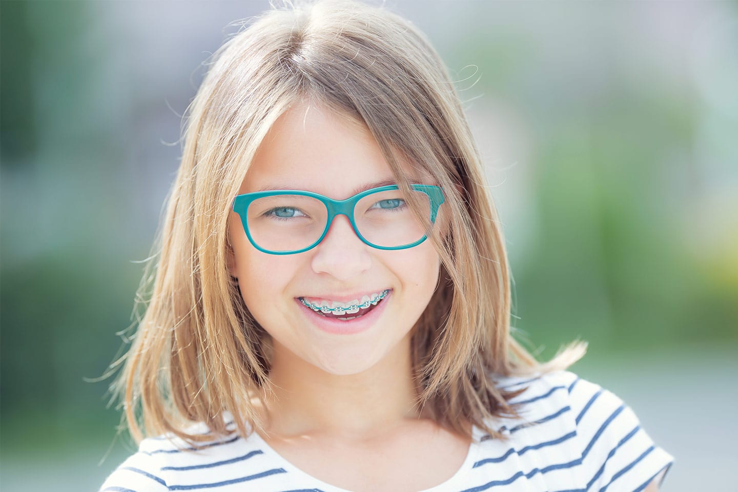 little girl with glasses and braces smiling in chattanooga