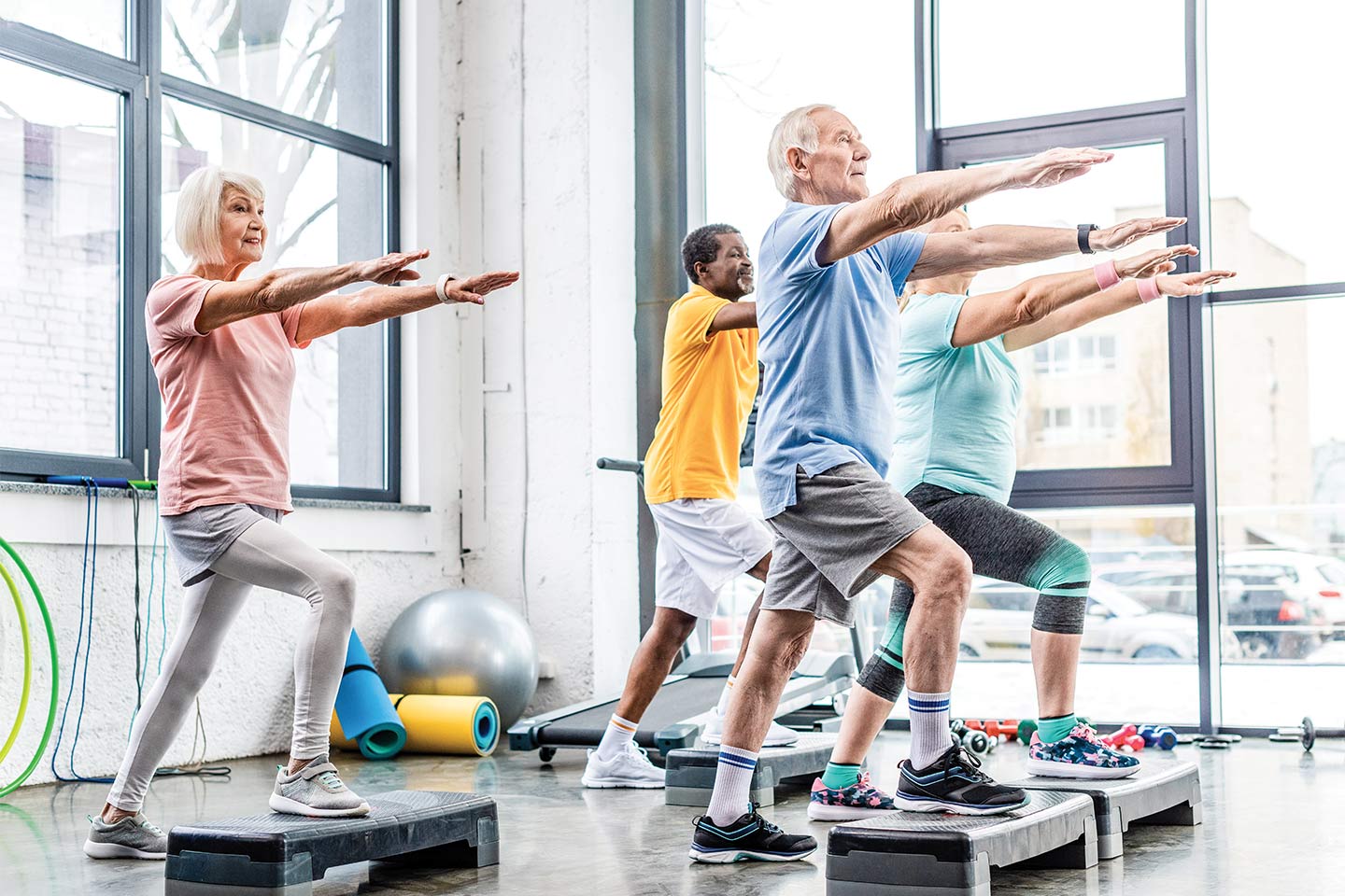senior adults doing step aerobics to keep their brains healthy