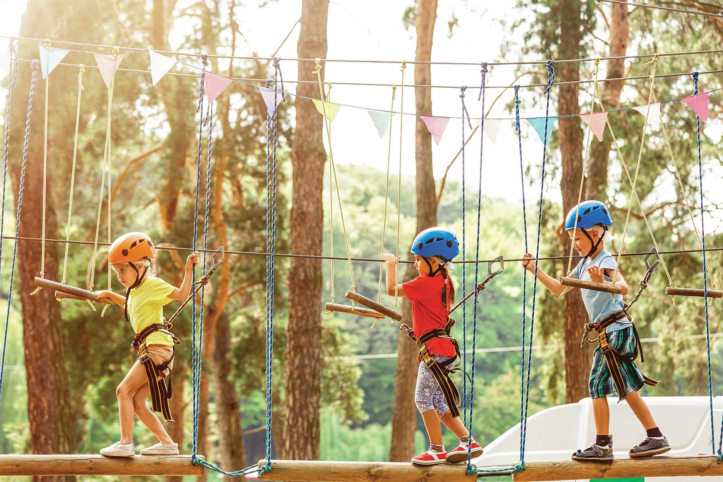 children navigating a high ropes course at summer camp