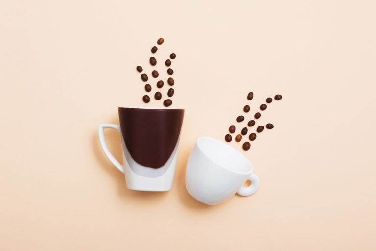 coffee cups with coffee beans coming off the top as steam
