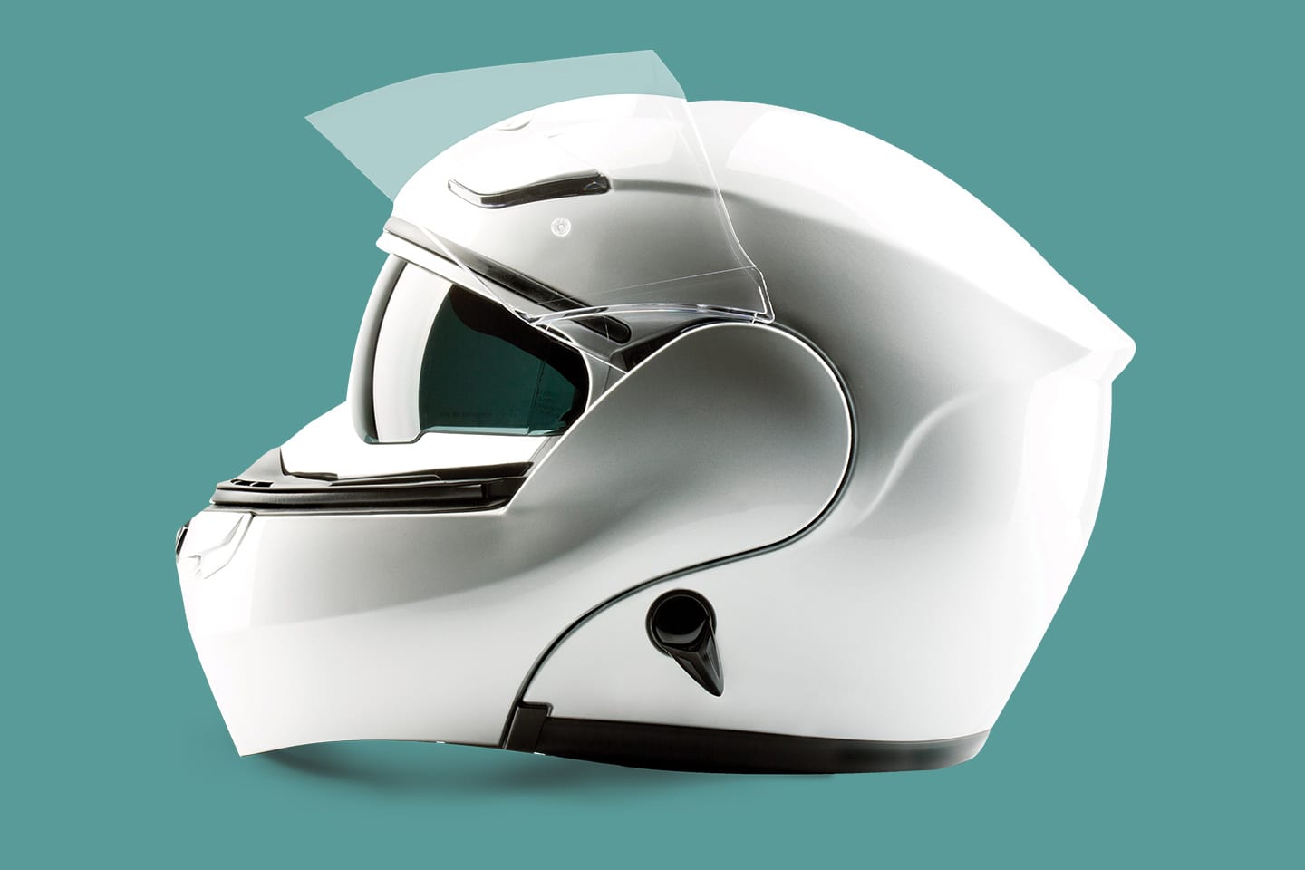 White motorcycle helmet on a teal background
