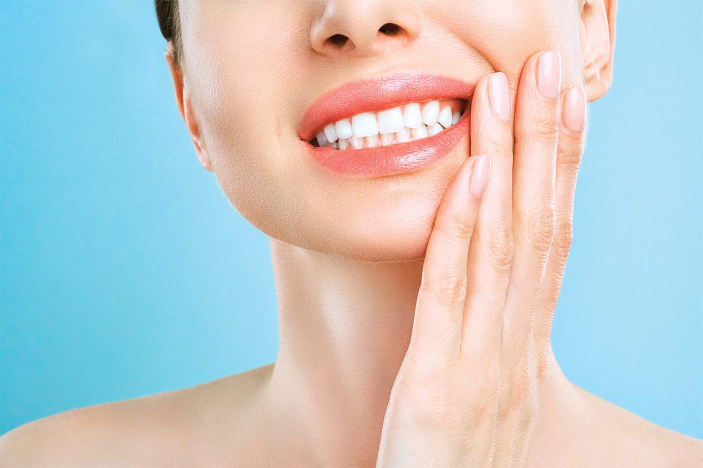 woman holding her jaw in pain