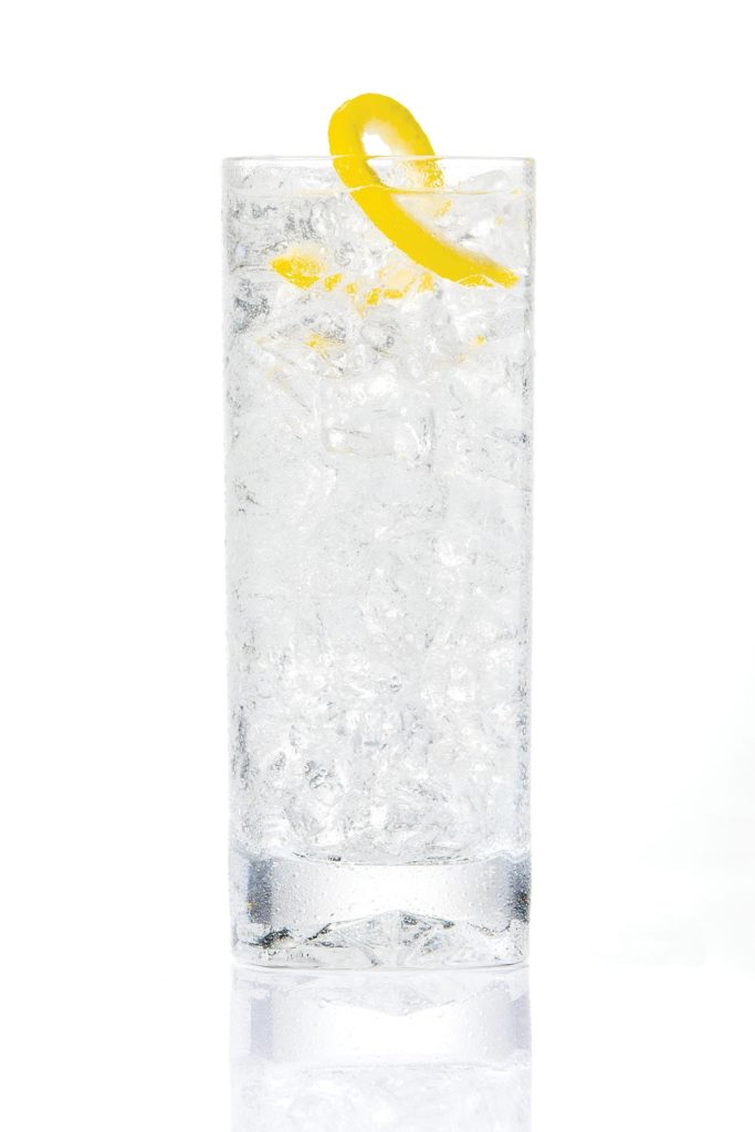 Tall glass of water with lemon