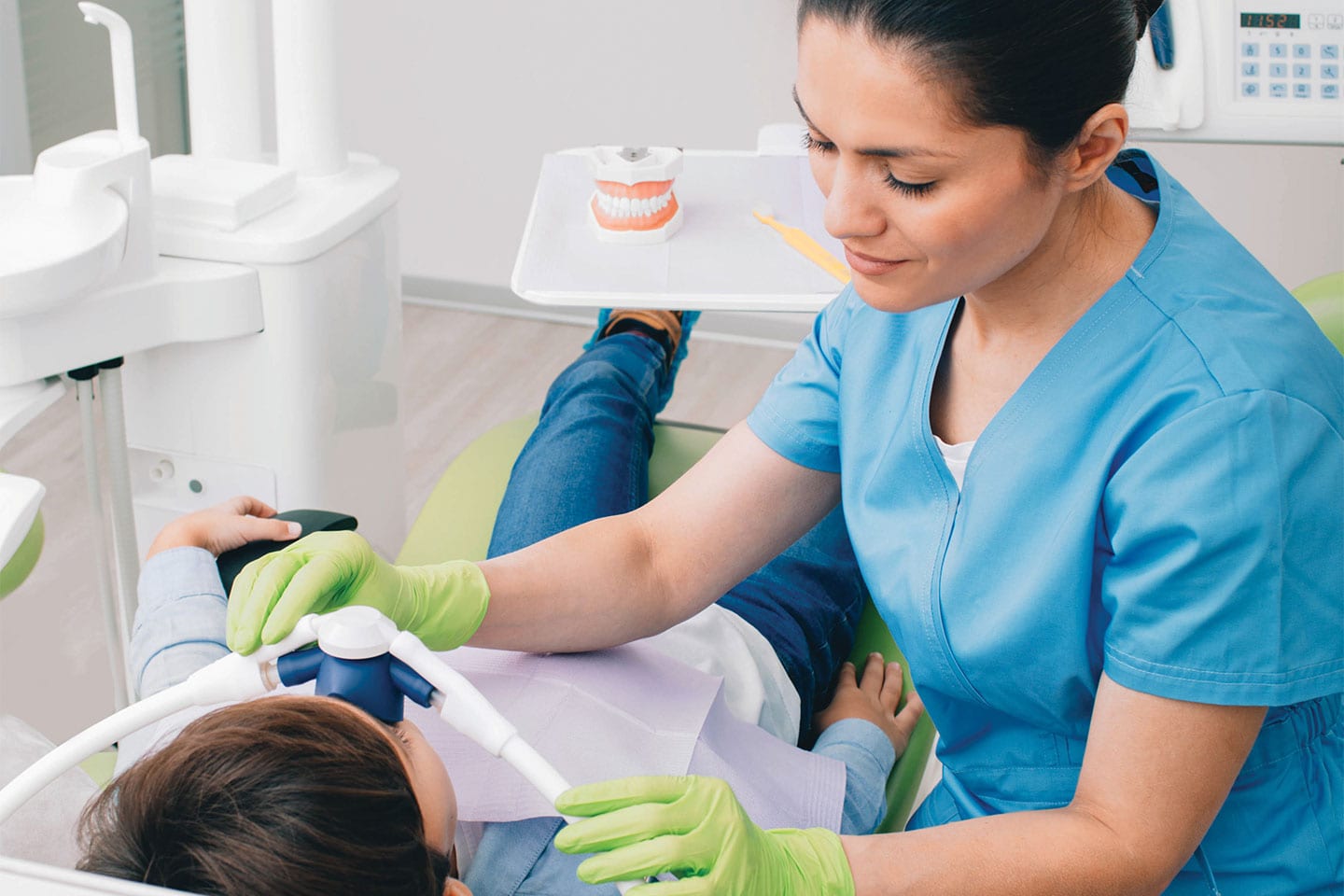 Dentist sedating a child patient
