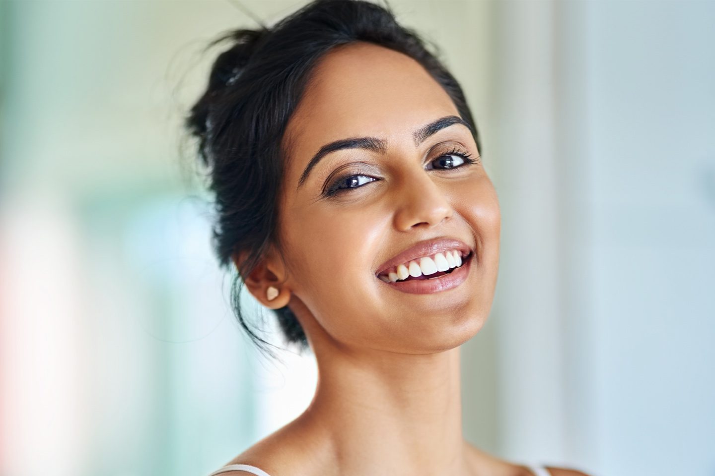 Happy woman with healthy teeth smiling