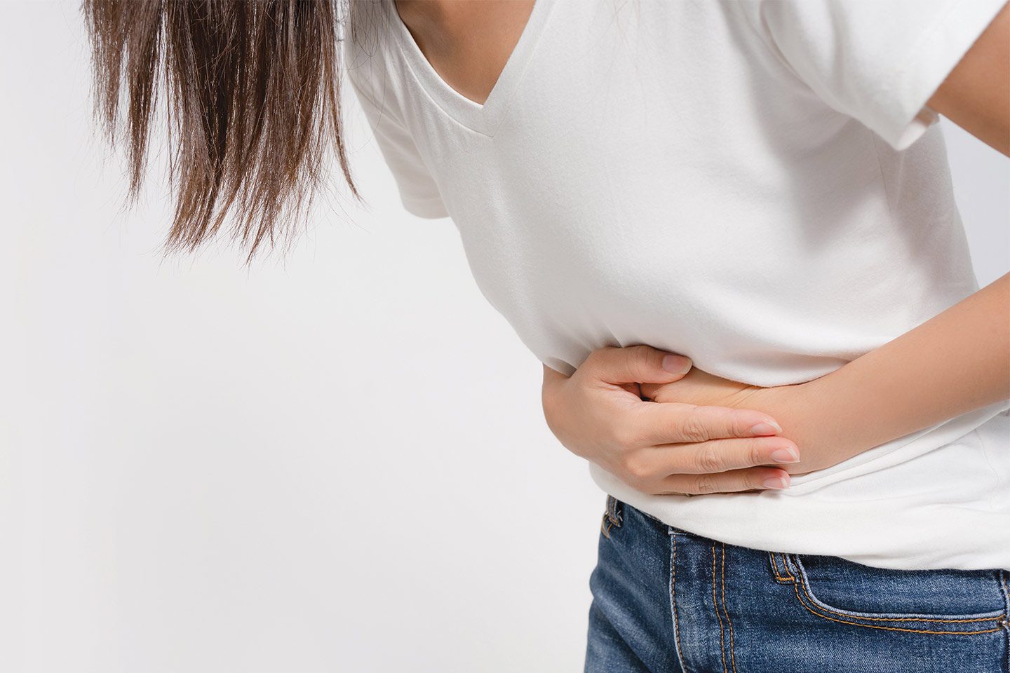 Woman clutching her stomach because of hernia pain