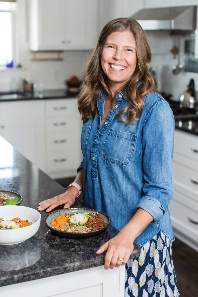 Maggie Tate in her kitchen with the Vegan Taco Lentils with Sweet Potatoes