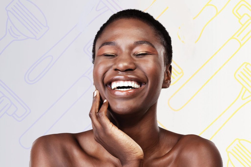 Happy woman with smooth exfoliated skin and razors behind her