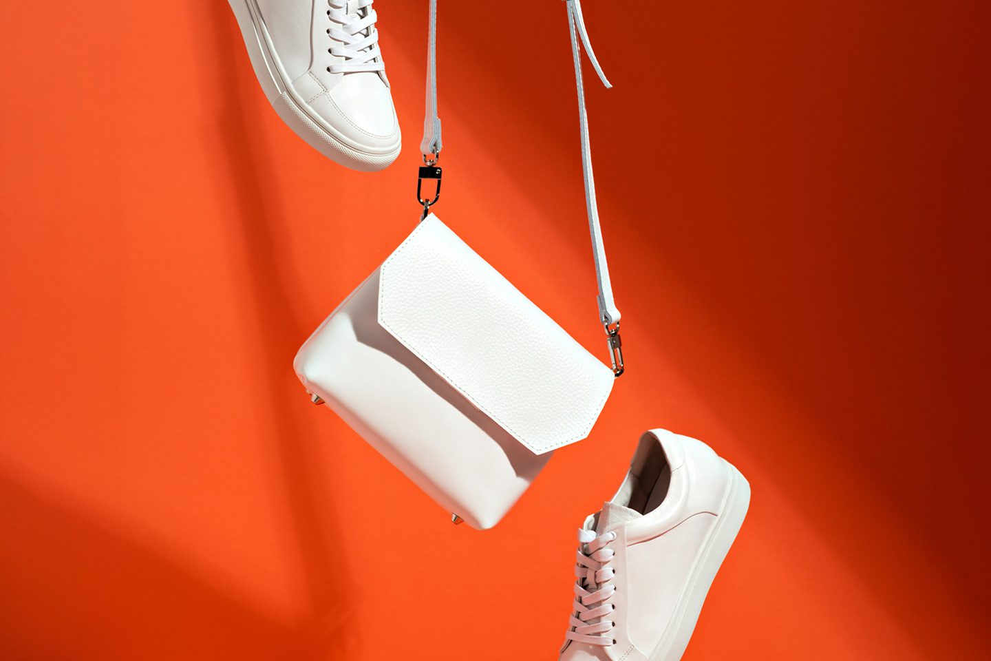 Leather shoes and purse on an orange background
