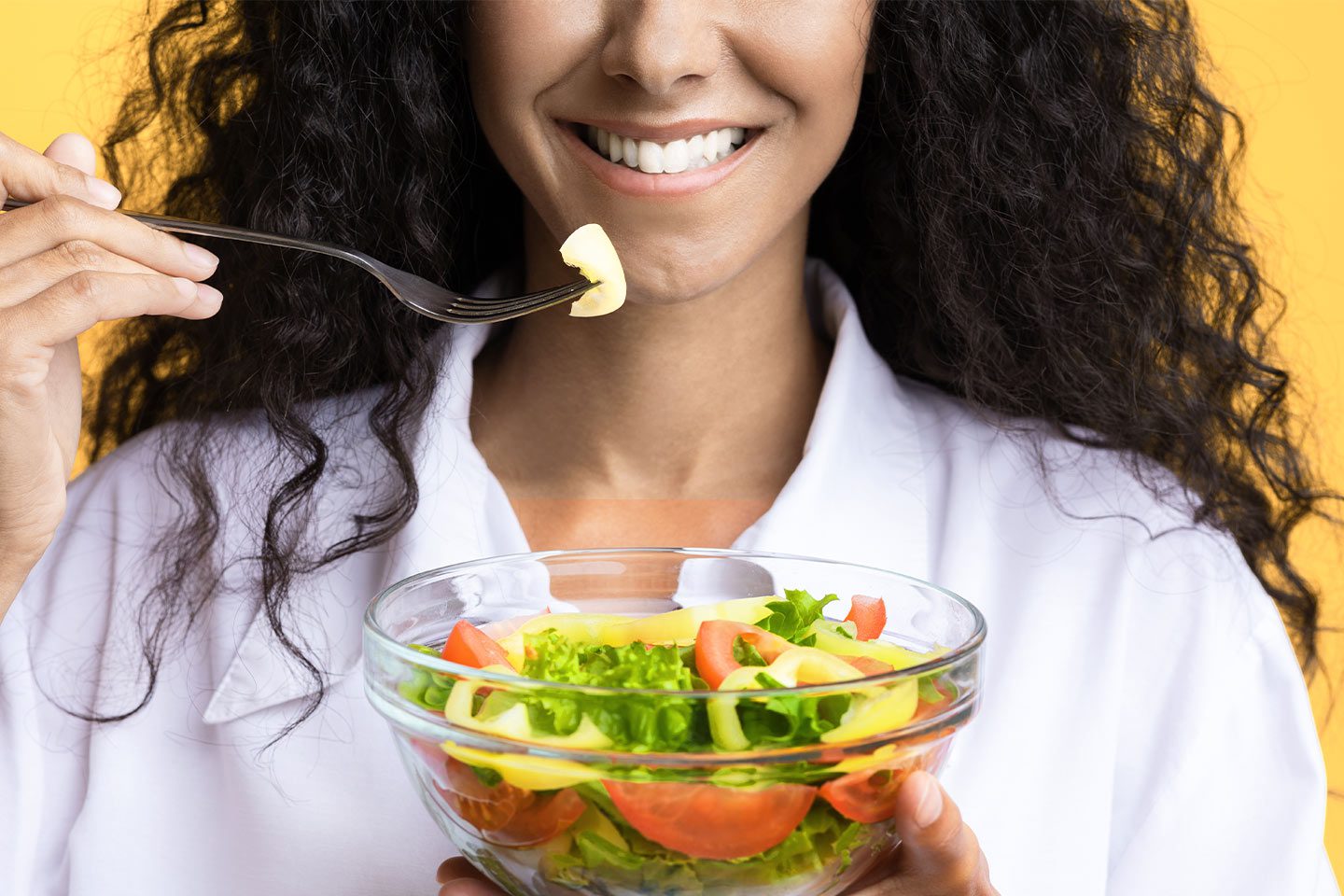 happy woman eating a vitamin rich diet with good teeth