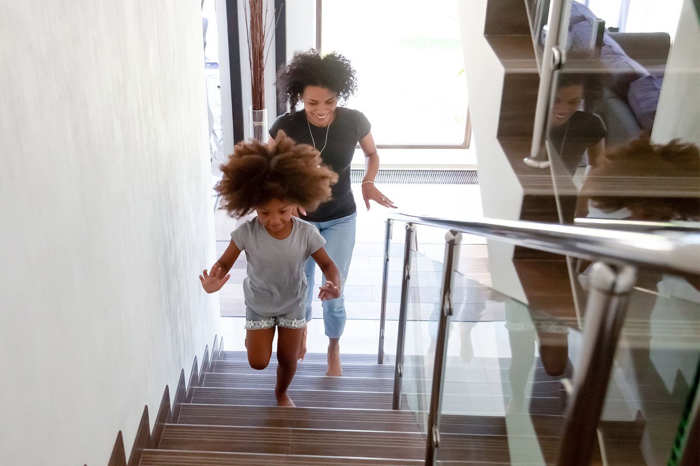 mother and daughter climbing stairs for exercise