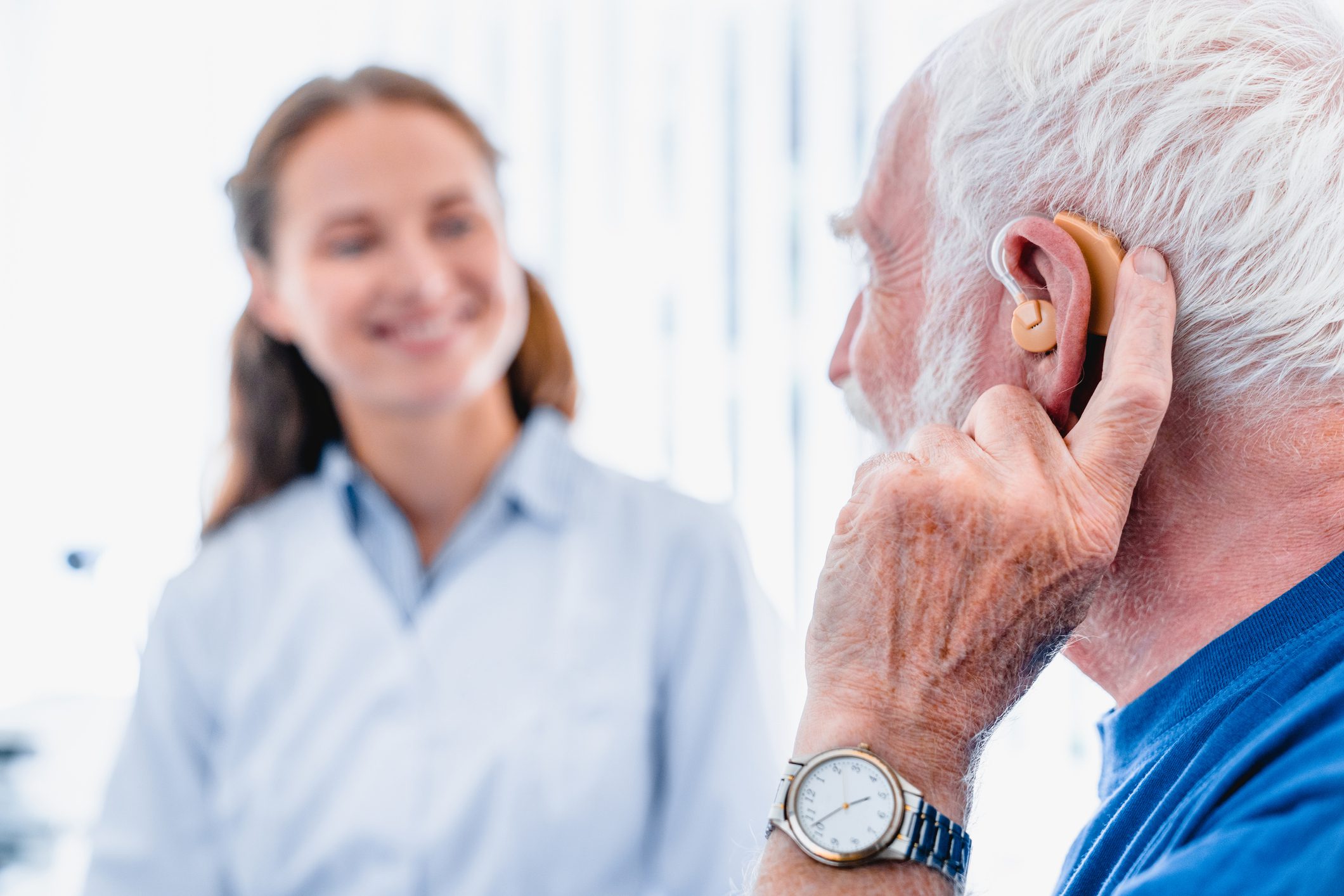Elderly male patient with hearing aid 