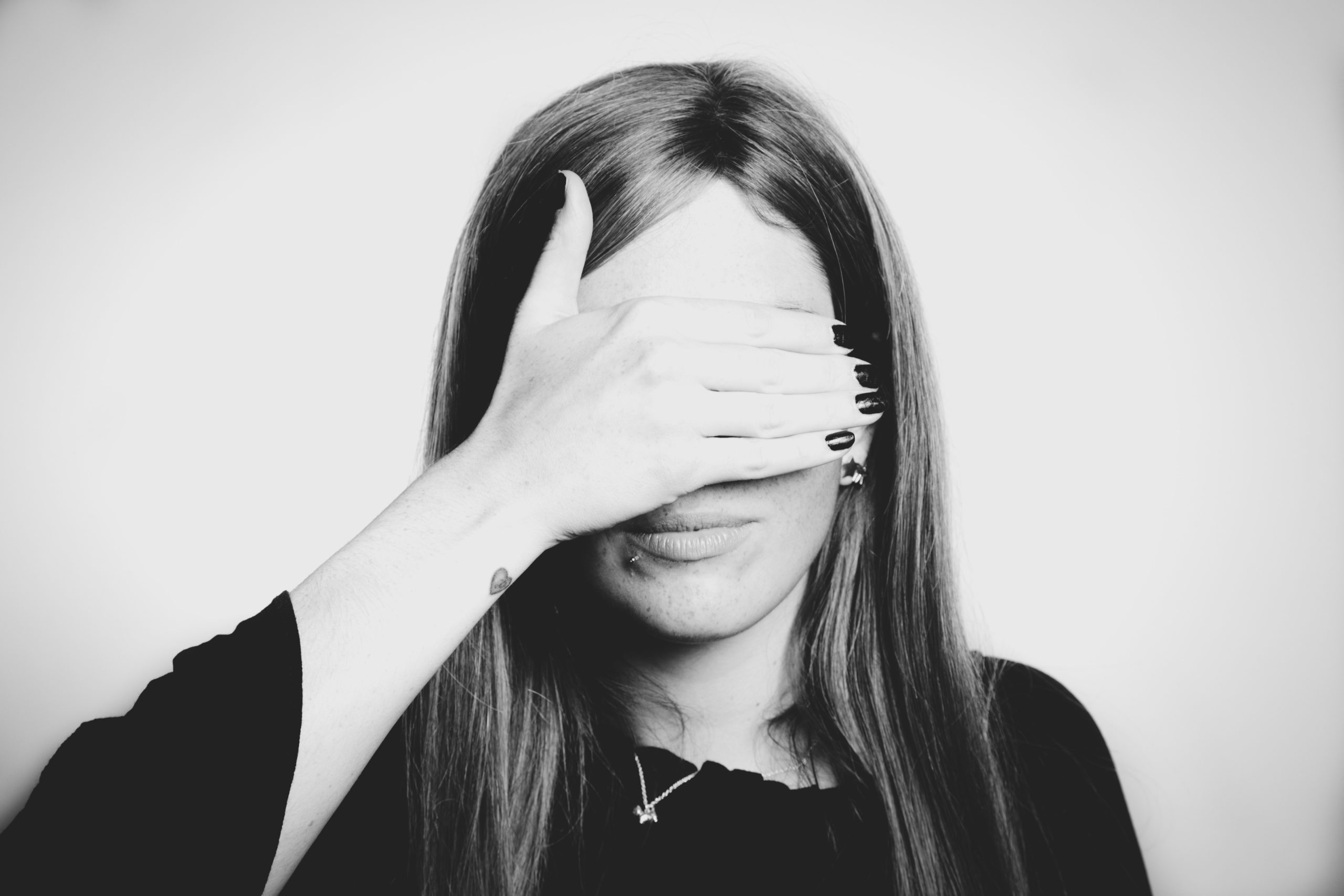 Woman covering her eyes