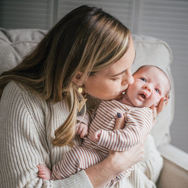 Kayla Jones kissing her baby boy Link