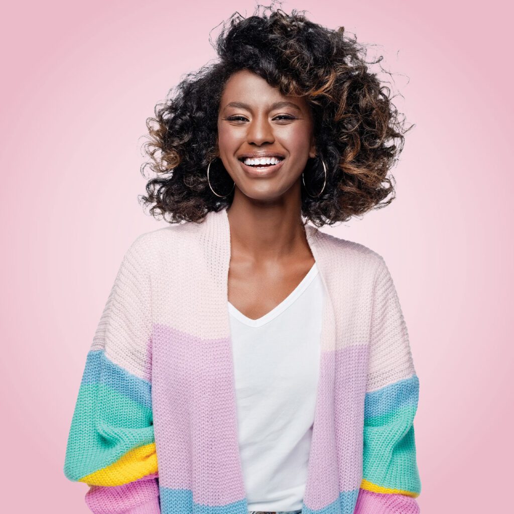 Smiling woman in pink background