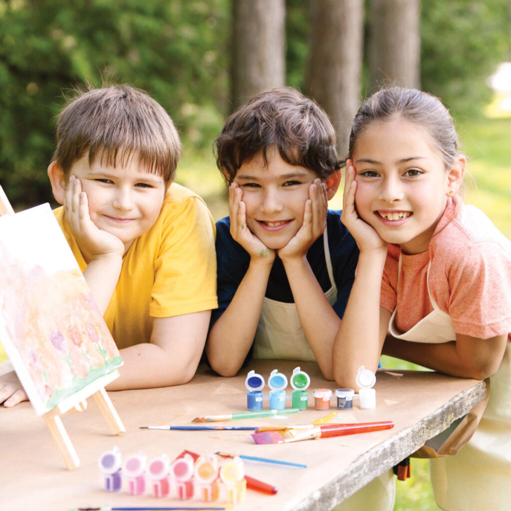children enjoying outdoor arts and crafts in summer camp