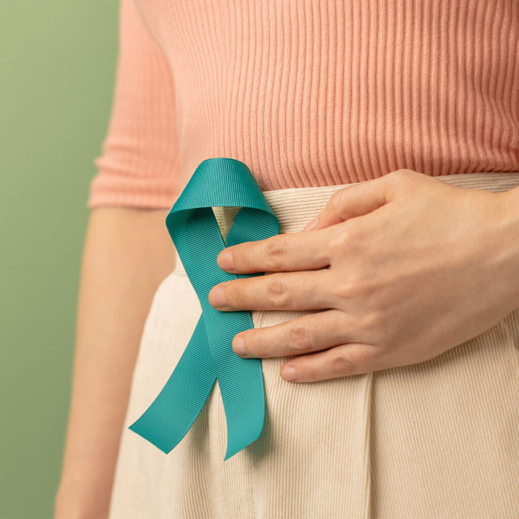 woman holding cervical health ribbon on stomach